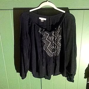 Black bohemian blouse with embellished front .